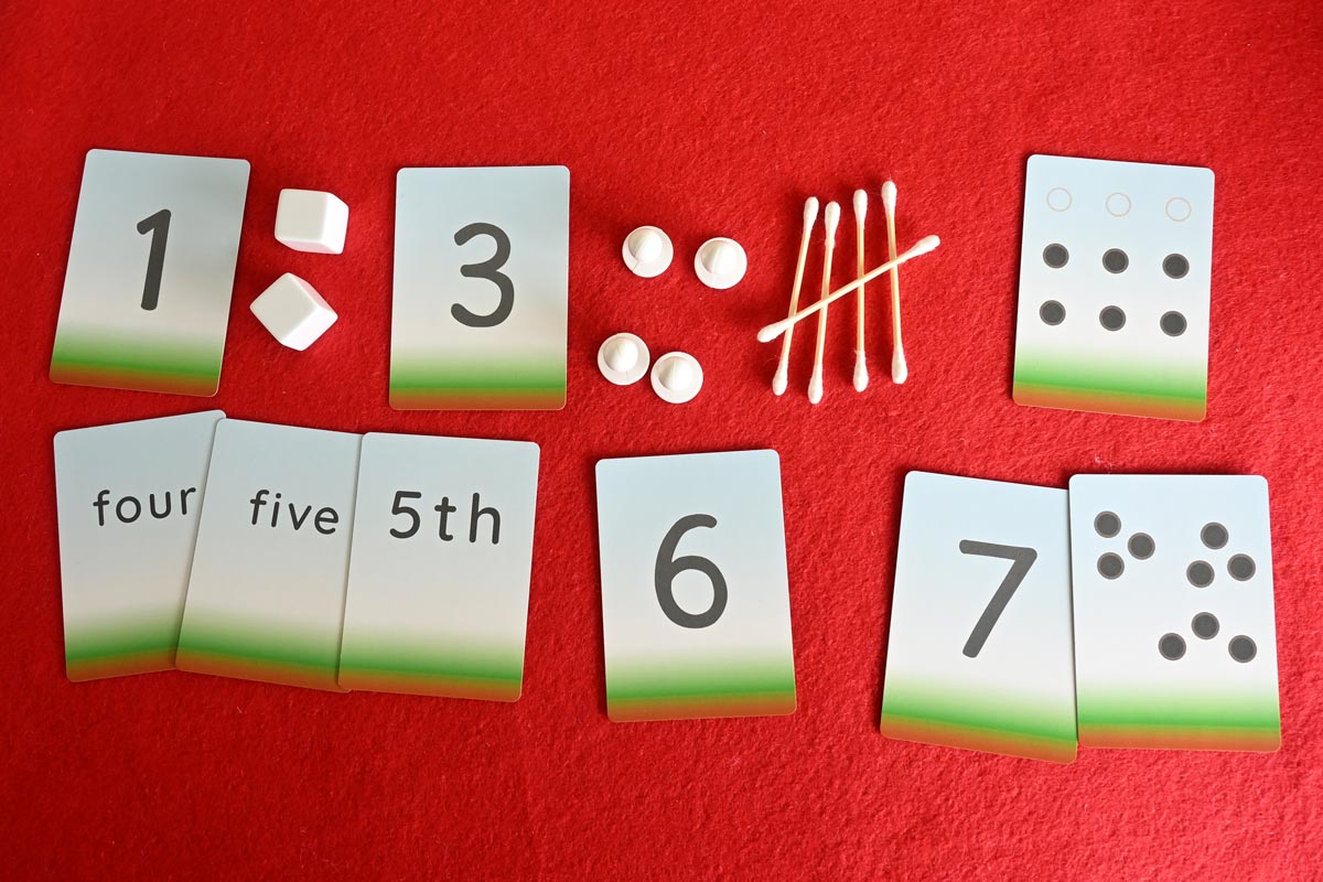 An upper row of mixed cards and objects: possibly in sequuential order. A lower row with a selection of possible matching cards.